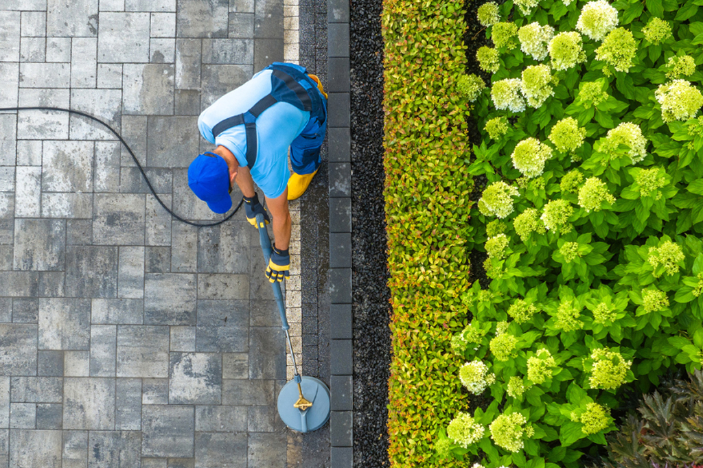 Man pressure washing driveway